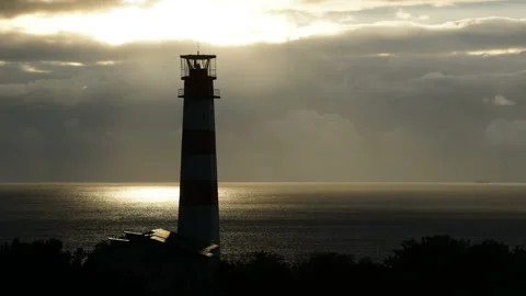 Lighthouse on the sea under stormy clouds and with the ship in the background Stock Footage 97564578