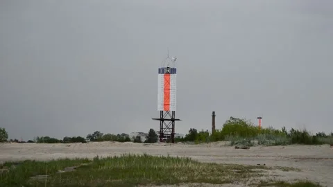 The lighthouse on the seashore is shining Stock Footage 144129700