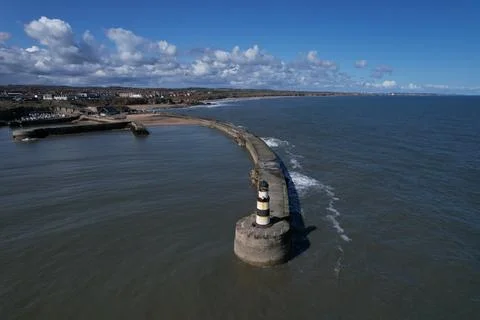 A lighthouse with seaside town in the background Stock Photos