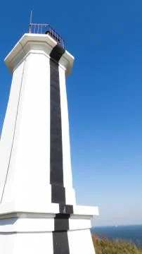 The lighthouse on the shore Stock Photos