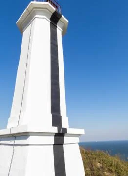 The lighthouse on the shore Stock Photos