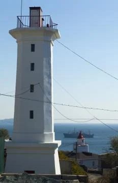 The lighthouse on the shore Stock Photos