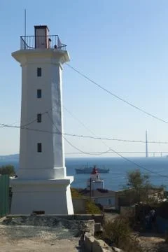 The lighthouse on the shore Stock Photos