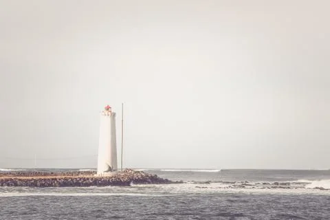 Lighthouse on a small island Stock Photos