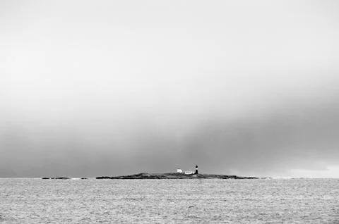 Lighthouse on small island Stock Photos