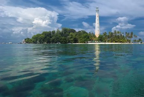 Lighthouse on small island Stock Photos