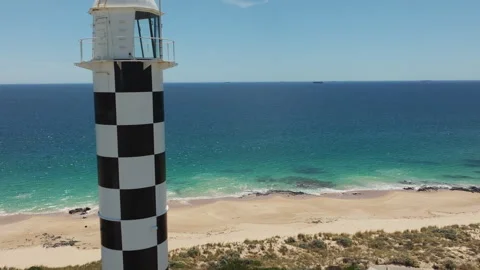 Lighthouse in a small town Drone Video Stock Footage 244031722