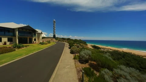 Lighthouse in a small town Drone Video Stock Footage 244031848