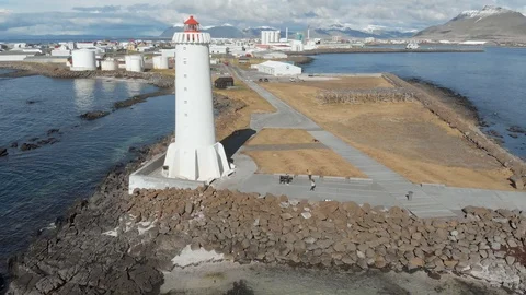 Lighthouse with snowy mountains in background Stock Footage 114165020