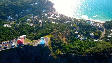 Lighthouse standing on a mountain above a small city in Australia Stock Footage 95898124