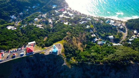 Lighthouse standing on a mountain above a small city in Australia Stock Footage 95898191