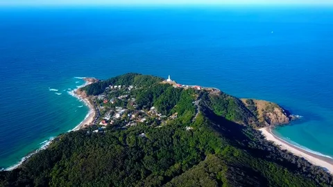 Lighthouse standing on a mountain above a small city in Australia Stock Footage 95898228