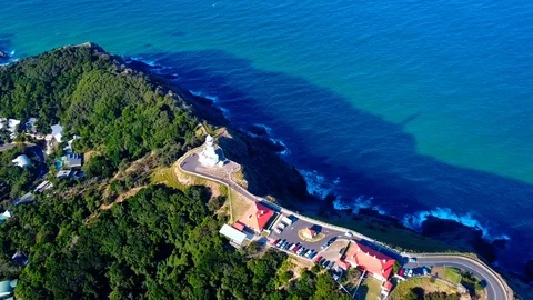 Lighthouse standing on a mountain above a small city in Australia Stock Footage 95898257