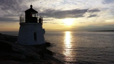 The lighthouse stands tall against the sunset over the ocean Video stock 312535329