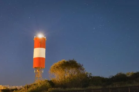 Lighthouse at starry night Stock Photos