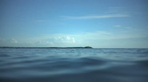 Lighthouse on a stone pier and the waves in a Baltic Sea Stock Footage 65311424