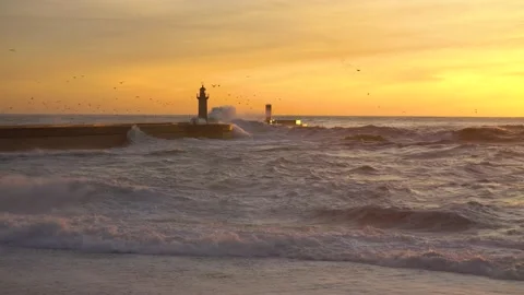 Lighthouse In Stormy Landscape. Big Waves. Sunset.  Stockbeeldmateriaal 229532319