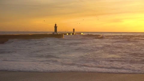 Lighthouse In Stormy Landscape. Big Waves. Sunset.  Stockbeeldmateriaal 229532320