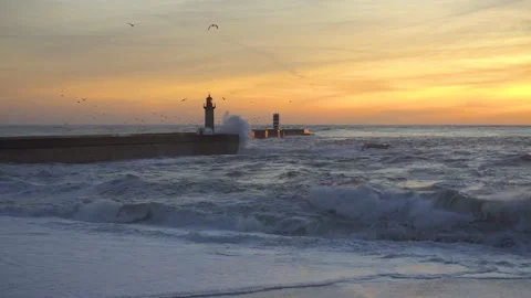 Lighthouse In Stormy Landscape. Big Waves. Sunset.  Stockbeeldmateriaal 229533491