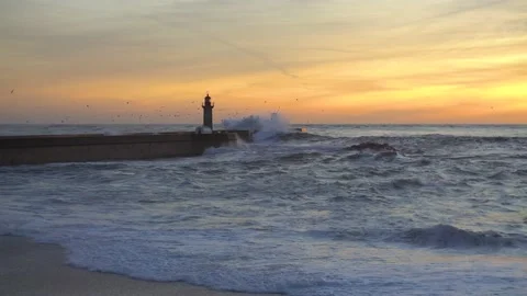 Lighthouse In Stormy Landscape. Big Waves. Sunset. Stockbeeldmateriaal 229533530