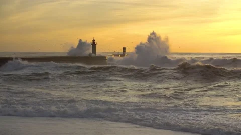 Lighthouse In Stormy Landscape. Big Waves. Sunset. Stockbeeldmateriaal 229533578