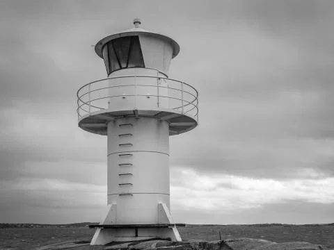 Lighthouse by the stormy ocean 스톡 사진