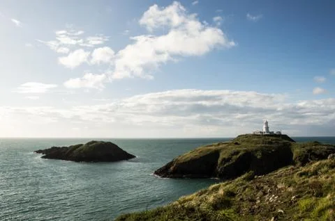 The lighthouse at Strumble Head, surrounded by a wild coastline Stock Photos