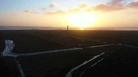 Lighthouse at sunset, aerial view, Approaching, passing by Stock Footage 123757660