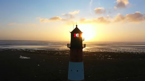 Lighthouse at sunset, aerial view, moving away Stock Footage 123733756