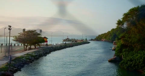 Lighthouse at Sunset in Background and a Bridge Fence in the Foreground Stockbeeldmateriaal 247460638