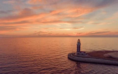 Lighthouse at sunset background Stock Photos