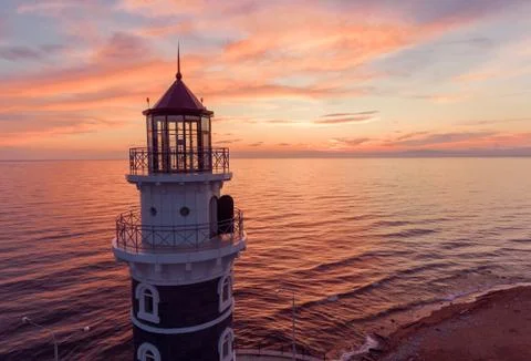 Lighthouse at sunset background Stock Photos