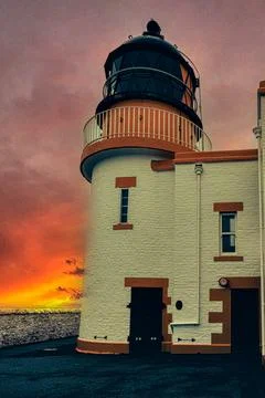 Lighthouse with sunset background. Stock Photos