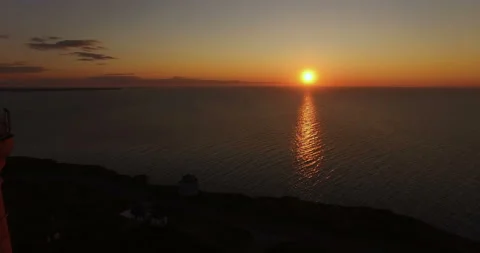 Lighthouse on a sunset background in the sea in summer Stock Footage 87846579