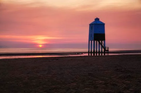 Lighthouse with sunset behind Stock Photos
