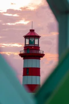 Lighthouse at Sunset lighthouse sunset pier conical redwhite Stock Photos