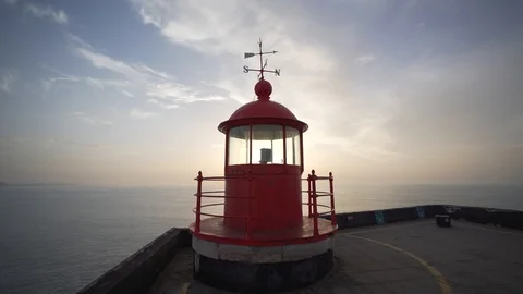 Lighthouse at sunset.  Tracking back shot. Nazaré, Portugal Stock Footage 122983462