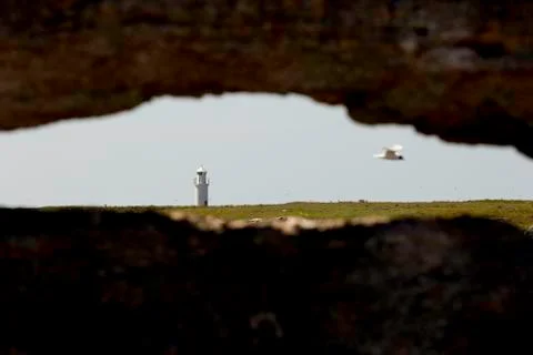 Lighthouse through Limestone Crack Stock Photos