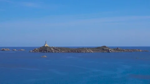 Lighthouse on a Tiny Rocky Island in the Mediterranean Sea Stock Footage 76727111