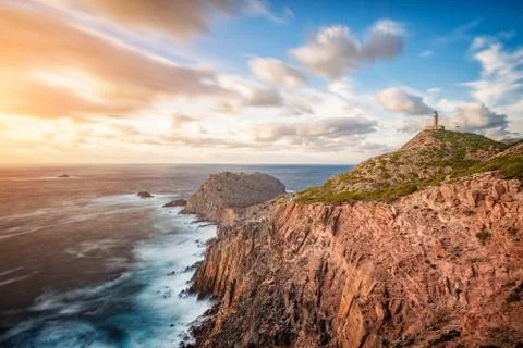 Lighthouse on the top of the cliff at sunset with long exposure. - Isola di P Stock Photos
