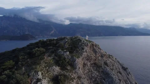 Lighthouse on top of a mountain on the St. Nicholas Island from drone Stock Footage 232836467