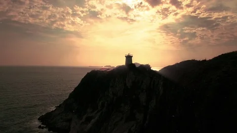 Lighthouse towards the sunset over the ocean Stock Footage 93782031