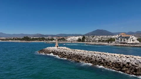 Lighthouse tower breakwater marina Puerto Banus Marbella coastal aerial 動画素材 336449042