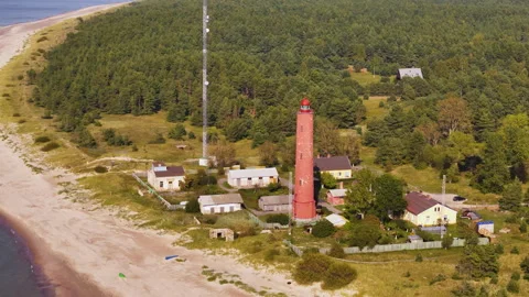 Lighthouse tower landscape, watchtower building at green forested beach aerial Vídeos de archivo 296270689