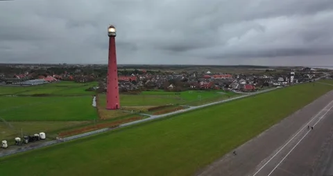 Lighthouse tower Lange Jaap in Den Helder drone aerial footage 5K along the sea Stock Footage 166638500