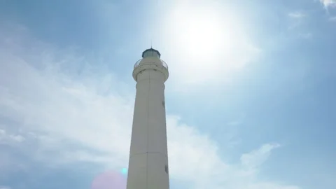 Lighthouse tower under cloudy sky Stock Footage 242415964