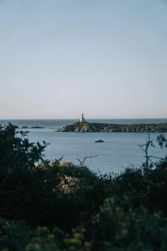 Lighthouse view on the sea. Lighthouse in the background. Sunrise Stock Photos