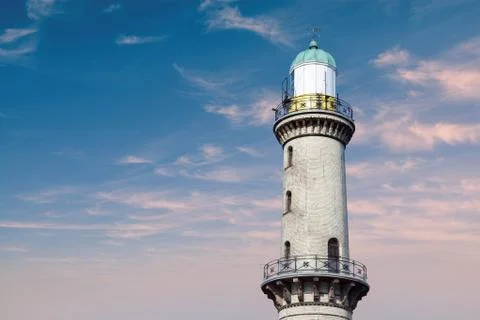Lighthouse in warnemuende rostock infront of a dramatic evening sky Stock Photos