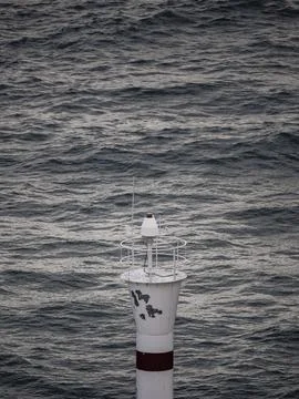 Lighthouse with waves crashing behind Stock Photos
