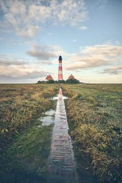 Lighthouse Westerheversand with leading pathway Stock Photos